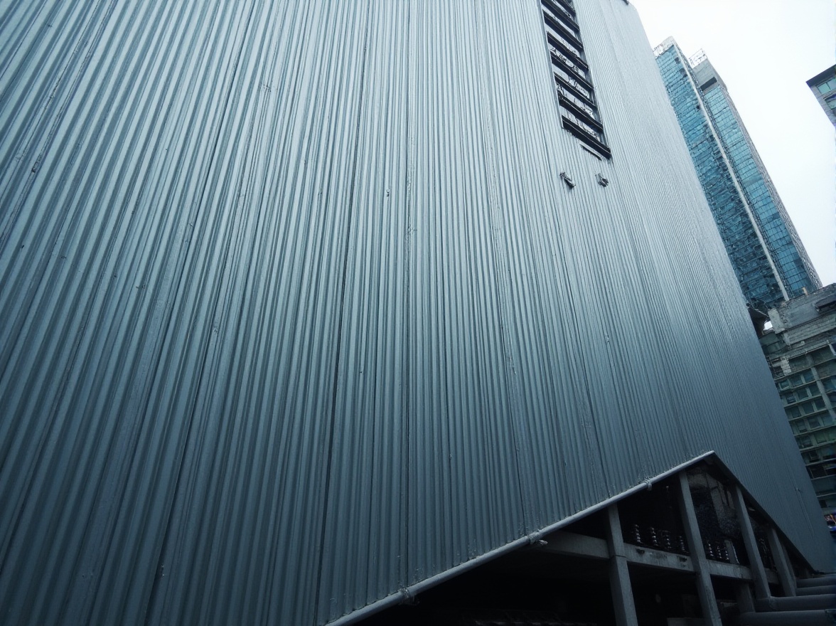 Prompt: Modern building, corrugated metal wall, silver color, metallic texture, urban landscape, cityscape, skyscraper, abstract composition, low-angle shot, dramatic lighting, futuristic ambiance, industrial feel, angular lines, geometric shapes, minimalist design, brutalist architecture, concrete foundation, steel beams, modern materials, high-tech look.