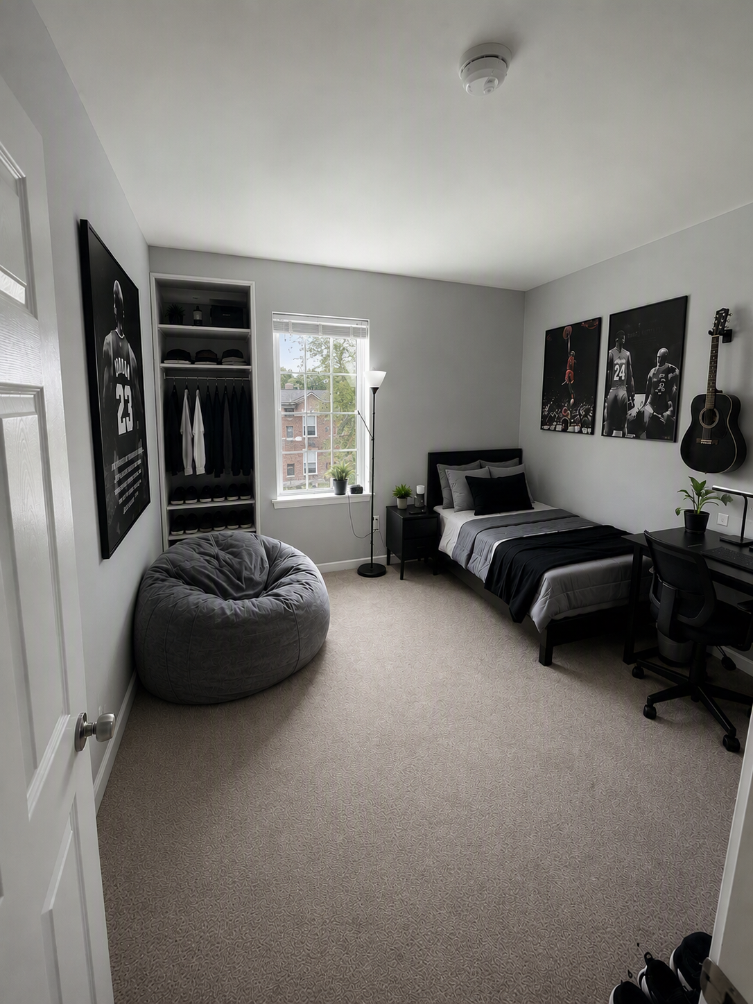 A high-quality, modern bedroom with a minimalist design, featuring a gray bean bag chair, a single bed with black and gray bedding, a black desk with a — boys bedroom ideas reference 1